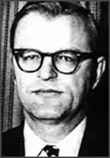 A person wearing glasses and a suit

Description automatically generated with medium confidence