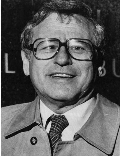 A person wearing glasses and a tie

Description automatically generated
