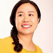 A person with a braided hair
Description automatically generated