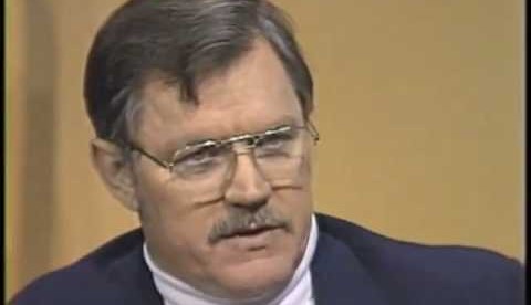 A person with a mustache wearing glasses

Description automatically generated