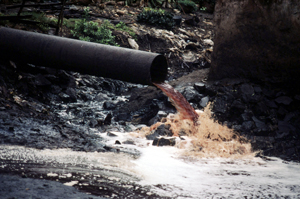 A pipe with a red substance coming out of it
Description automatically generated