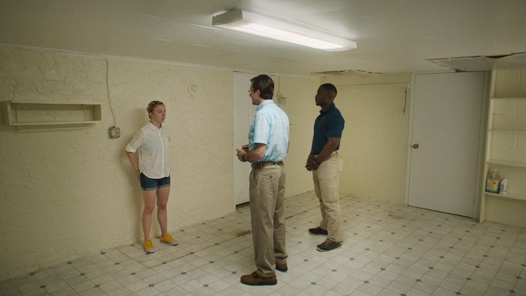 A group of people standing in a room

Description automatically generated