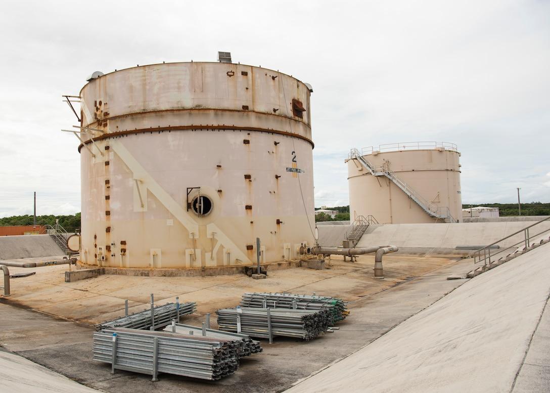 A large white silos with metal pipes
Description automatically generated with medium confidence