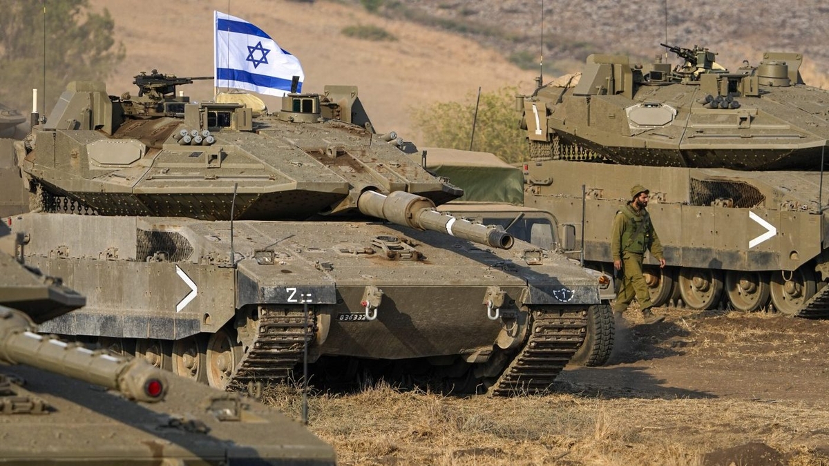A military tank with a flag on it
Description automatically generated