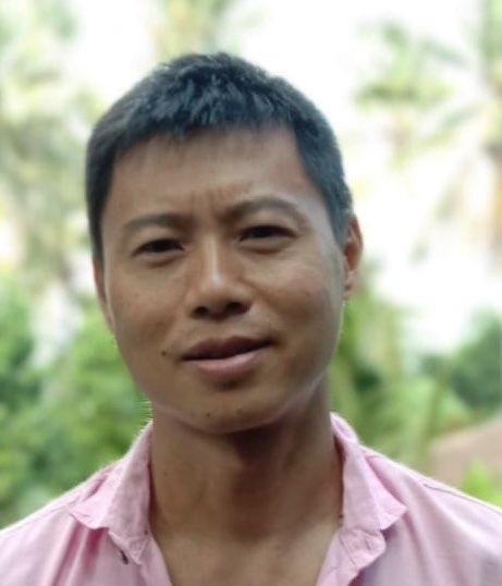 A person in a pink shirt
Description automatically generated