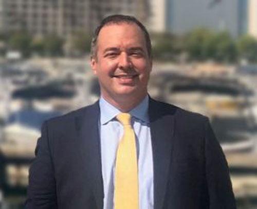 A person in a suit and tie
Description automatically generated