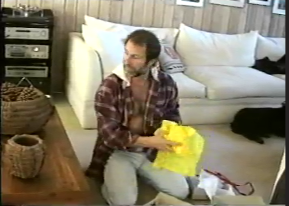 A person sitting on the floor holding a yellow bag

Description automatically generated