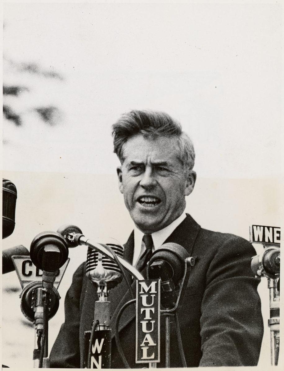 A person speaking into a microphone

Description automatically generated
