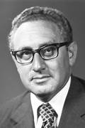 A person wearing glasses and a suit

Description automatically generated