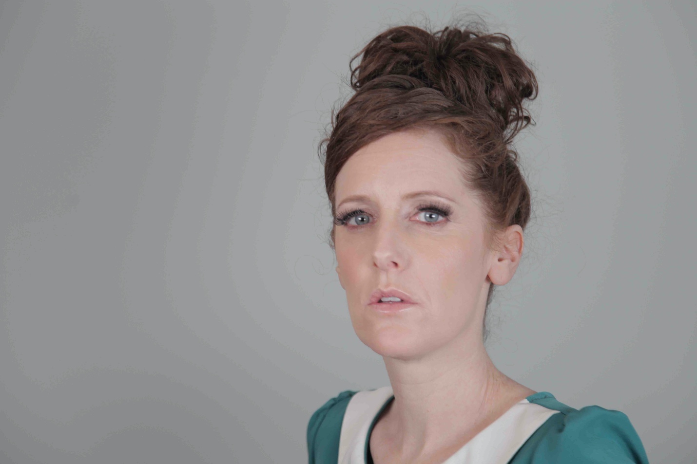 A person with a high bun

Description automatically generated