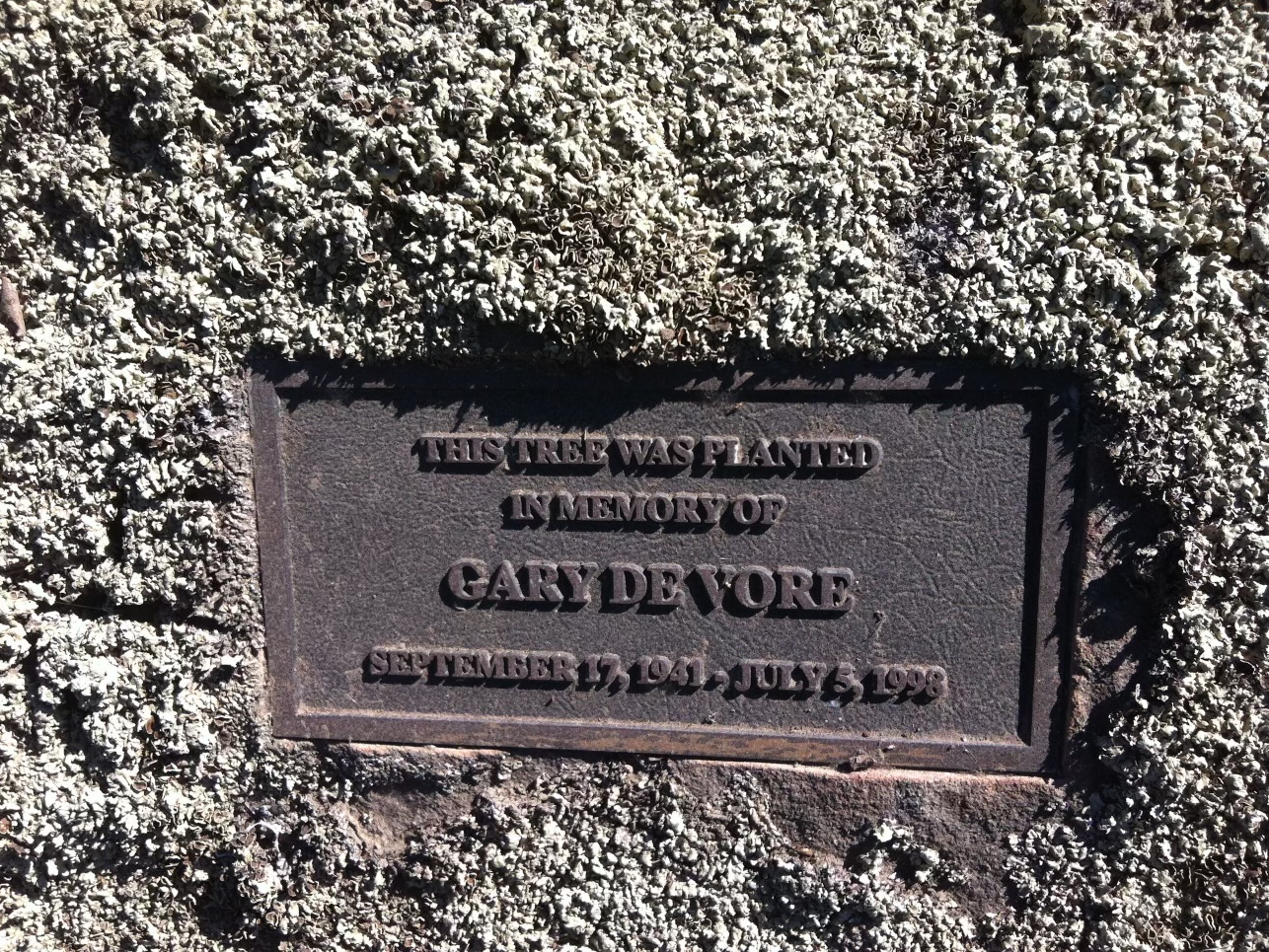 A plaque on a rock

Description automatically generated