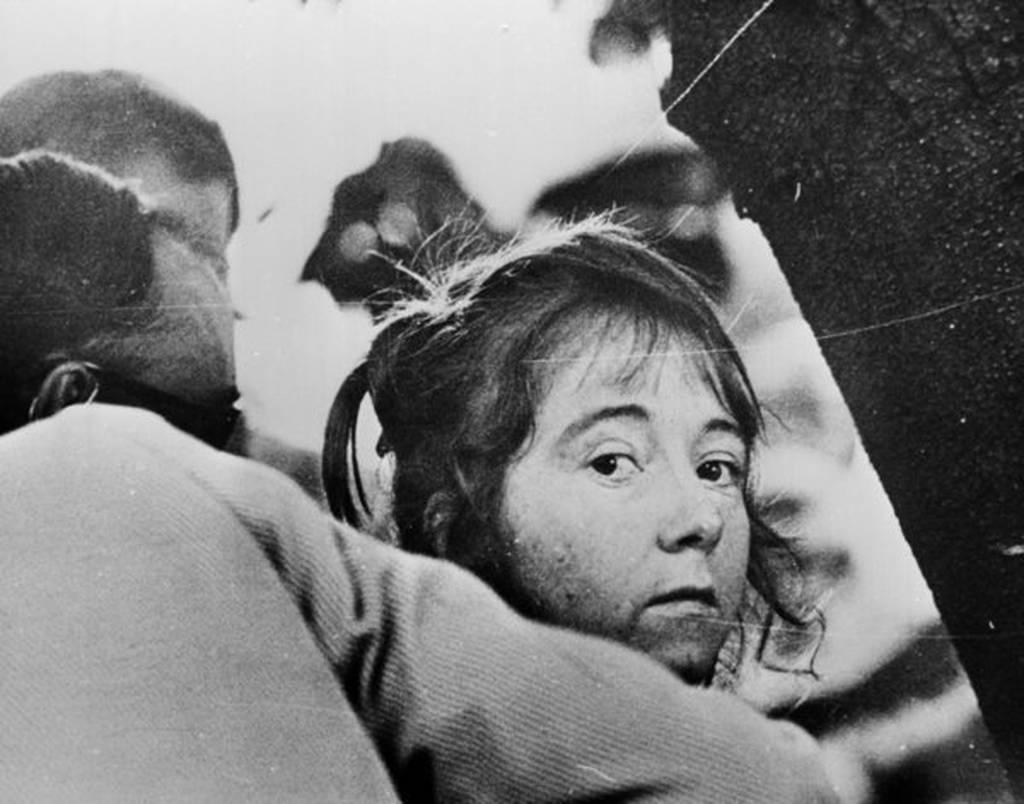 Lynette "Squeaky" Fromme, an acolyte of Charles Manson, being led away after her failed attempt in 1975 to kill President Ford.