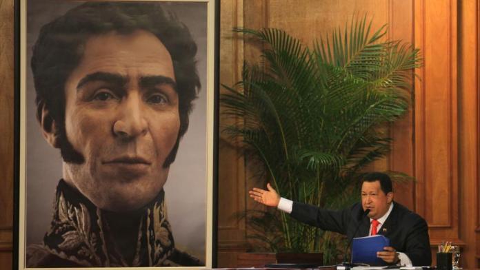 Venezuela's late President Hugo Chavez unveils a photograph-like portrait of Venezuela's independence hero Simon Bolivar on the 229th anniversary of Bolivar's birth at Miraflores Presidential Palace in Caracas, Venezuela, Tuesday, July 24, 2012.