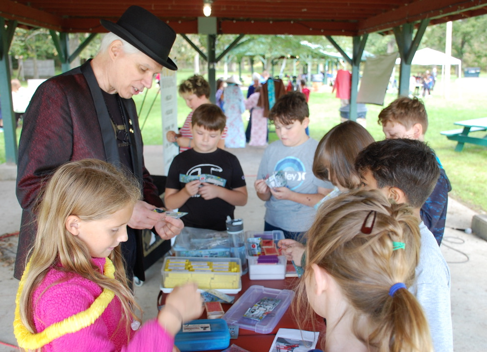 A group of children playing with cards
Description automatically generated