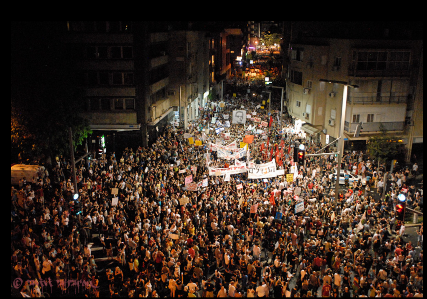 A large crowd of people protesting

Description automatically generated