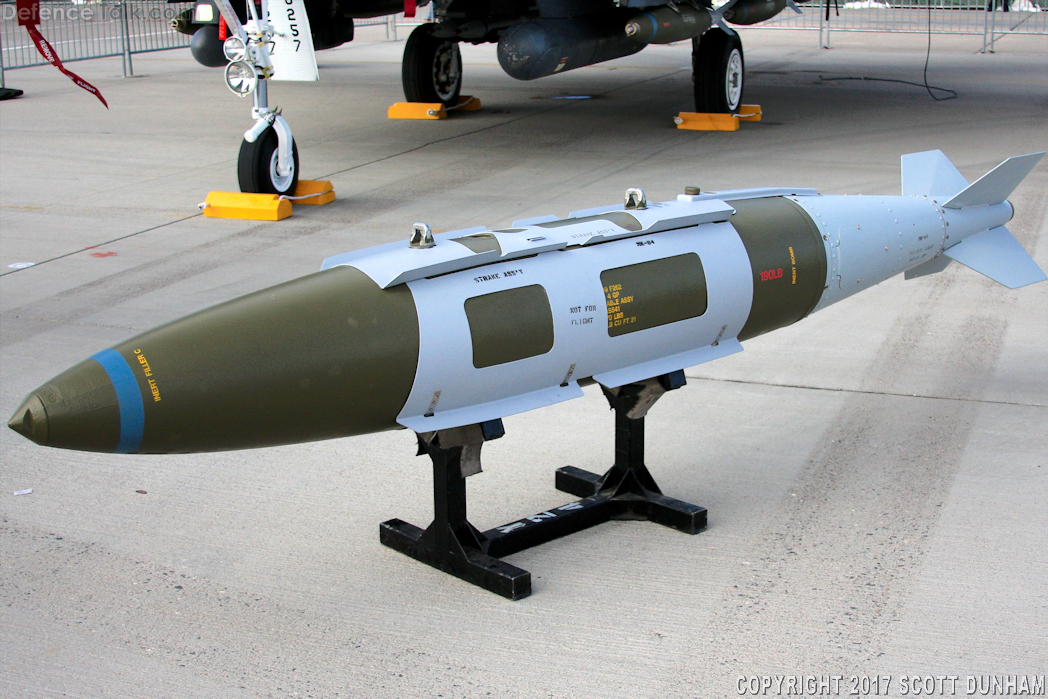 A missile on display on a stand
Description automatically generated