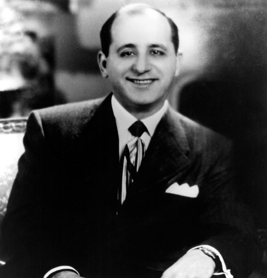 A person in a suit and tie

Description automatically generated with medium confidence