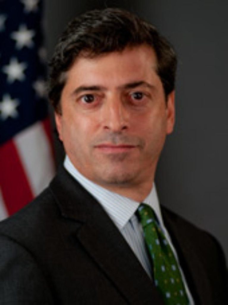 A person in a suit and tie
Description automatically generated with medium confidence