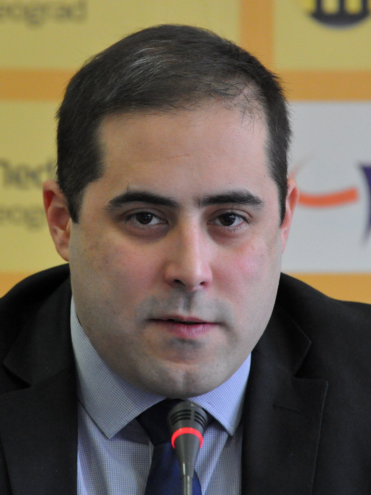 A person in a suit and tie
Description automatically generated