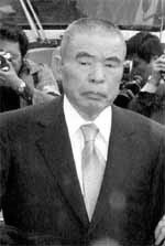 A person in a suit
Description automatically generated