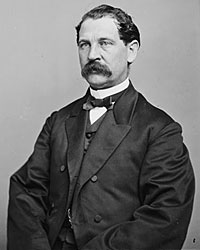 A person in a suit with Seated Lincoln in the background
Description automatically generated