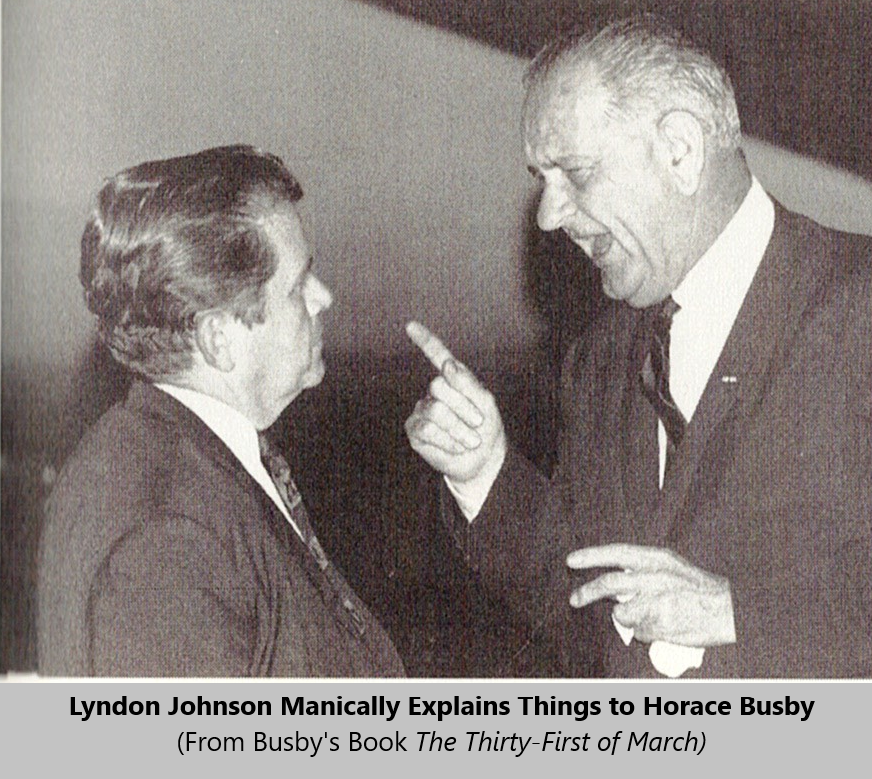 A person in suit pointing at another person

Description automatically generated