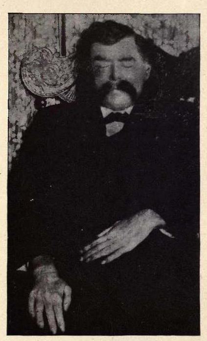 A person with a mustache and a bow tie
Description automatically generated