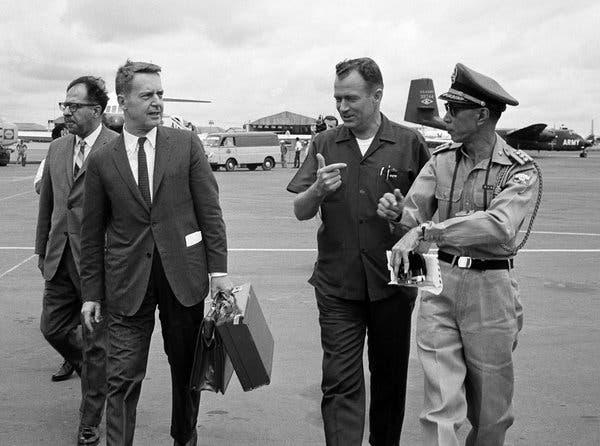 Edward G. Lansdale, second from left, arrives in Saigon, August 1965.