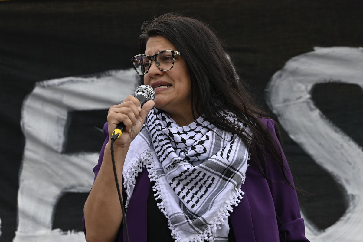 Tlaib speaks into a microphone.