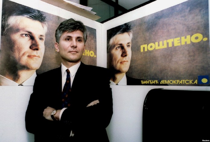 Zoran Djindjic, the leader of Serbia's Democratic Party, which he helped found, poses in front of election posters with the slogan "Fair" on December 23, 1993.