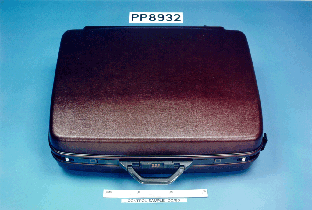 A brown briefcase with a white label

Description automatically generated