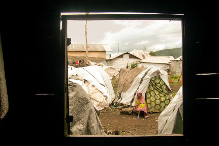 A displaced woman rests outside her tent in Kanyaruchinya camp in eastern Congo