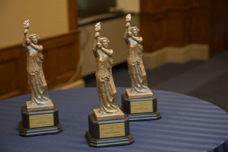 A group of bronze statues on a table

Description automatically generated