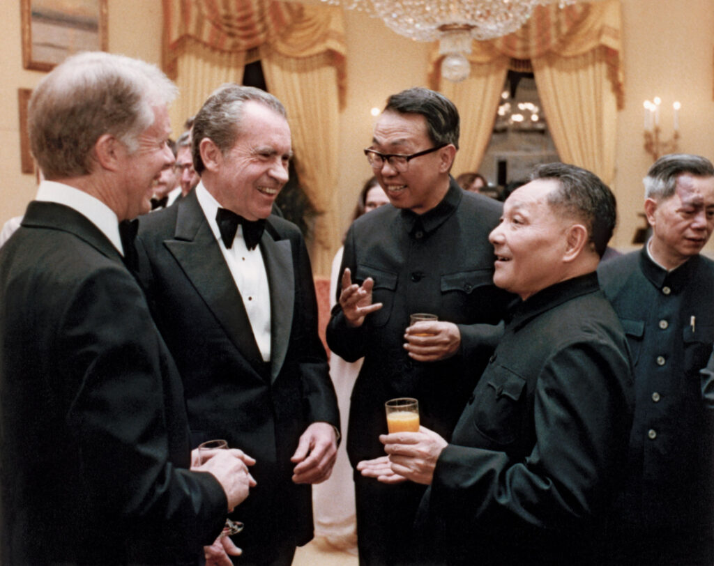 A group of men in black suits

Description automatically generated