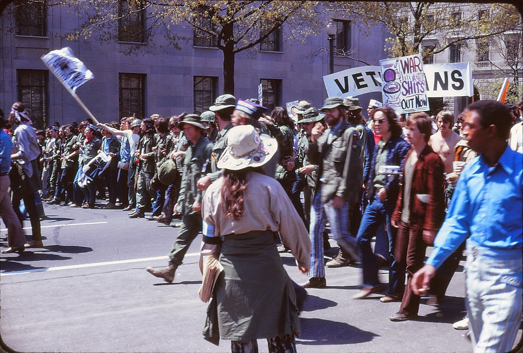 A group of people marching in a parade

Description automatically generated