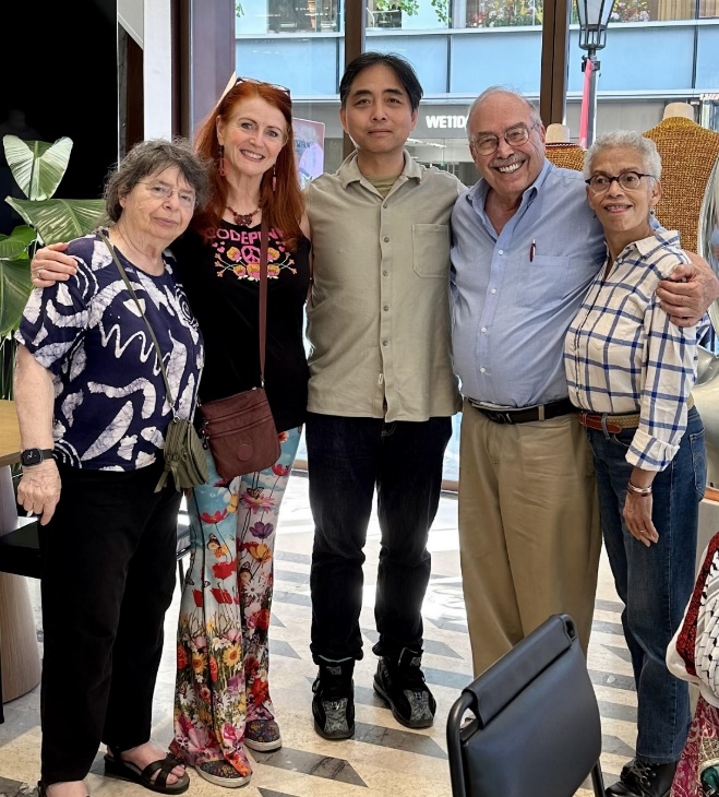 A group of people posing for a photo

Description automatically generated