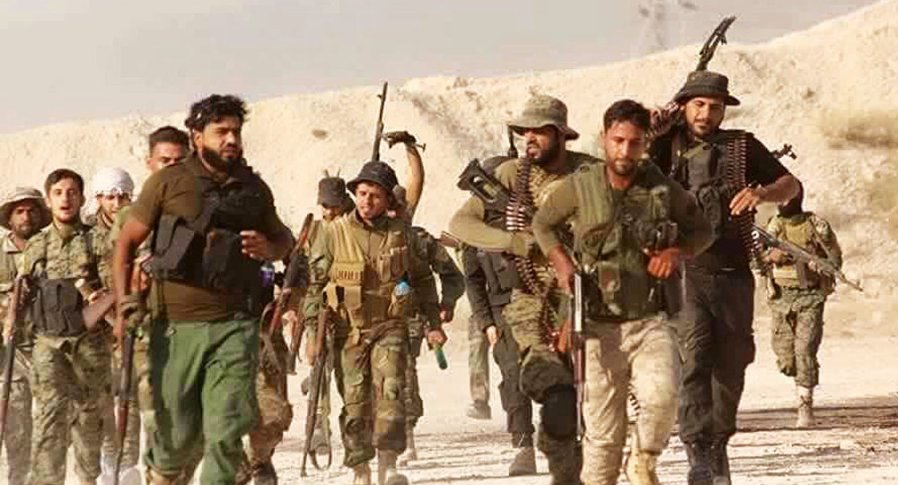 A group of soldiers walking with guns

Description automatically generated