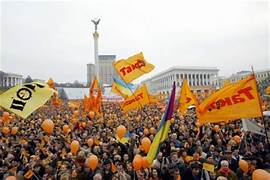 A large group of people holding flags

Description automatically generated