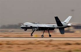 A military airplane taking off

Description automatically generated
