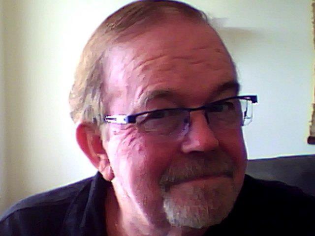 A person wearing glasses and a black shirt

Description automatically generated