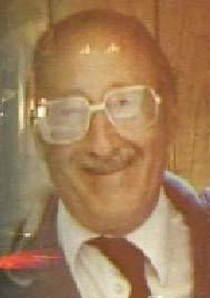 A person wearing glasses and a suit
Description automatically generated with medium confidence