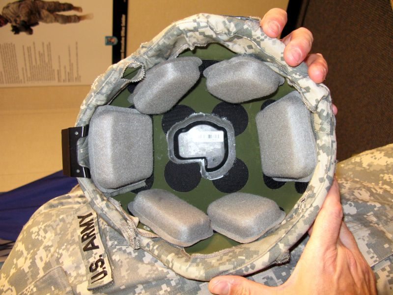 A close-up of a soldier holding a helmet
Description automatically generated
