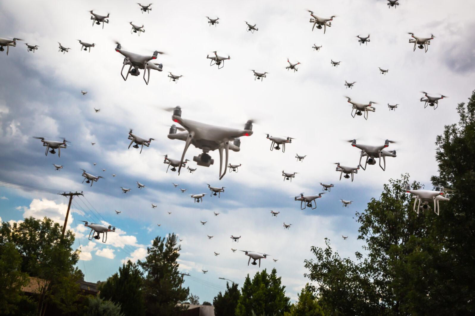 A group of drones flying in the sky

Description automatically generated