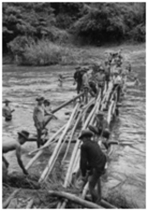 A group of people crossing a river

Description automatically generated