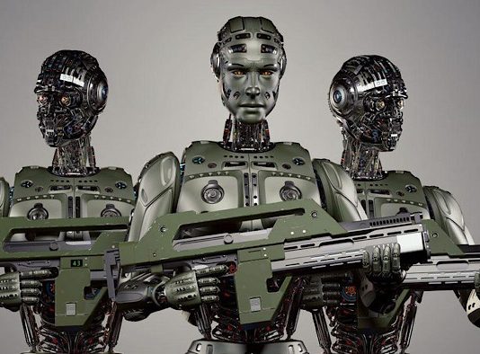 Pentagon Aims to Create a Human-Machine Soldier as Part of Dangerous New Artificial Intelligence Race A group of robots holding an object Description automatically generated