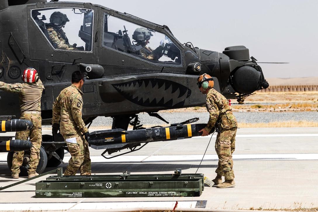 A group of soldiers loading a missile

Description automatically generated