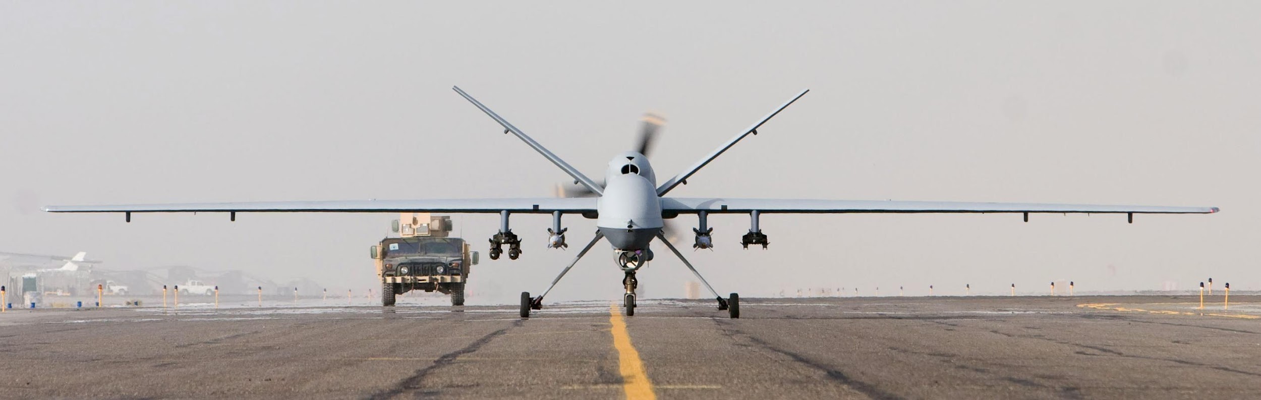 A military plane taking off

Description automatically generated