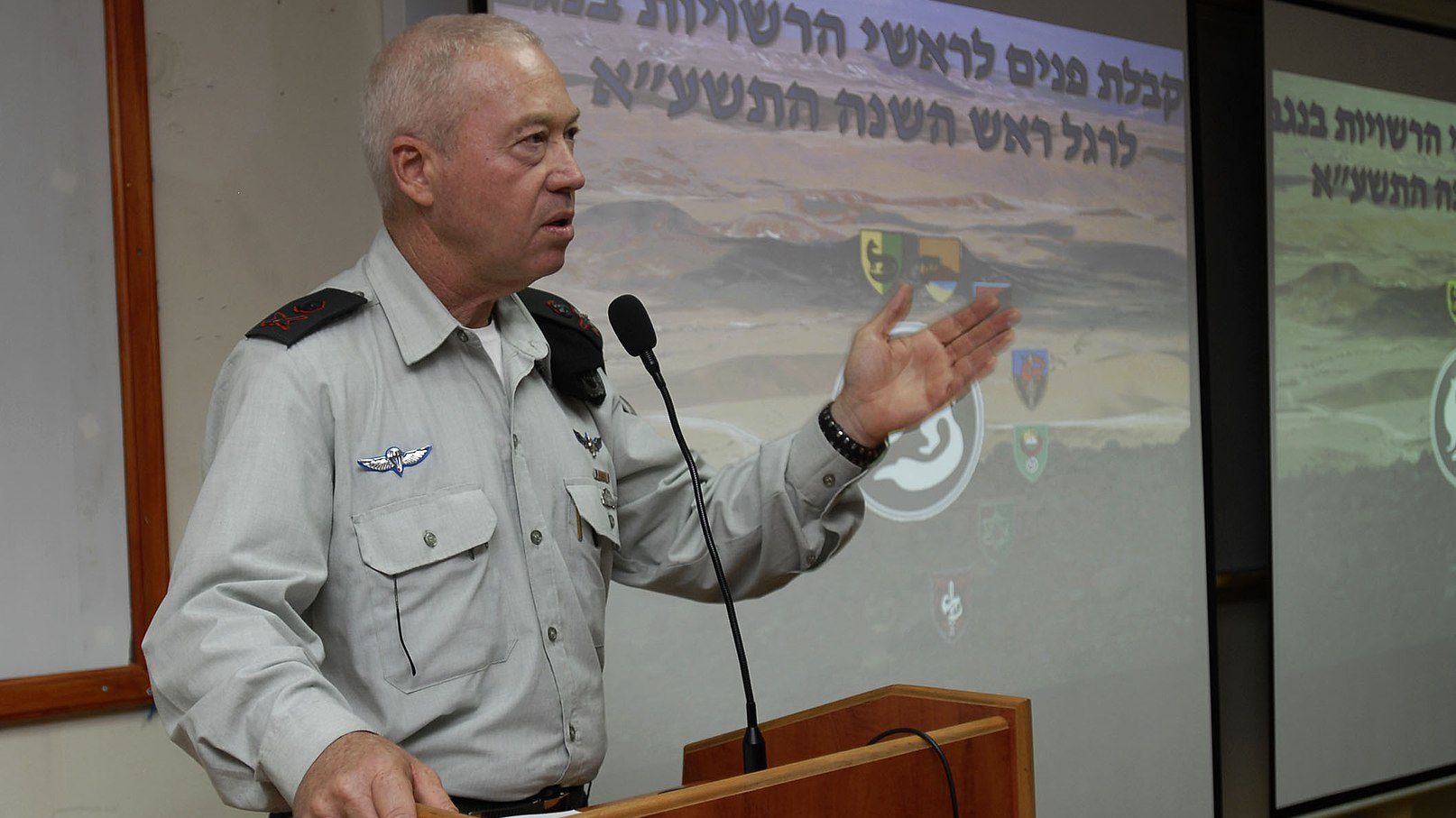 A person in uniform standing at a podium
Description automatically generated