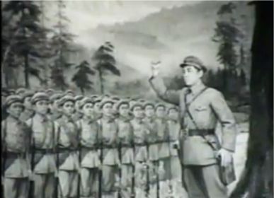 A person in uniform standing in front of a row of soldiers
Description automatically generated