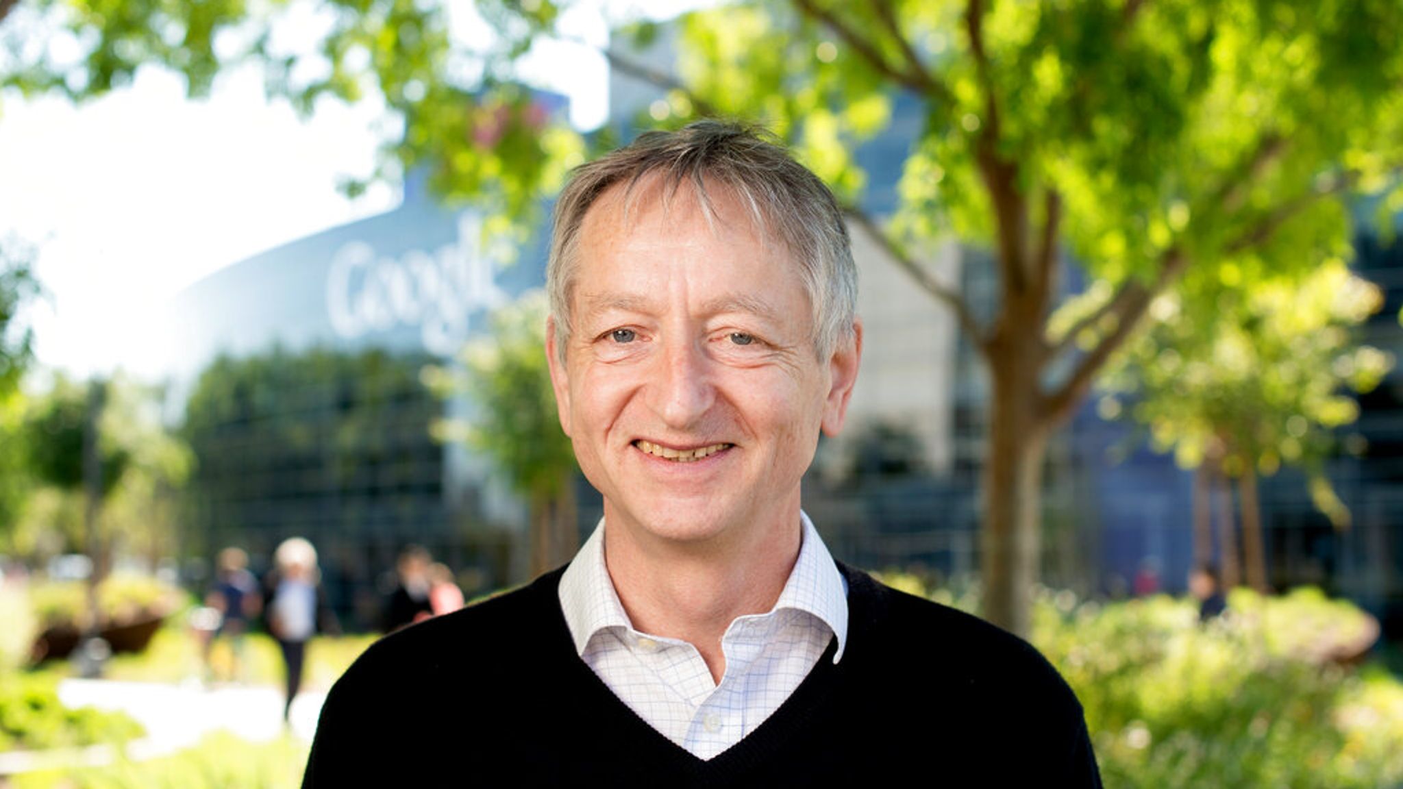 A person smiling at camera
Description automatically generated